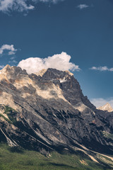 Scenic Alps with rocky mountain under blue sky