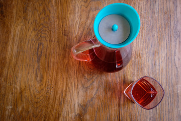 glass and jug of herbal fruit tea