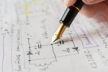 macro view of engineer planing the electrical circuit on paper