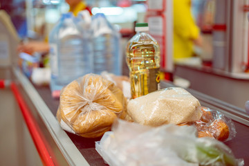 supermarket cashier with food on the conveyor to purchase on the weekend
