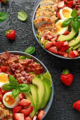 Chicken Cobb salad with strawberries, bacon, avocado and boiled eggs