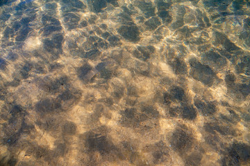 Fototapeta na wymiar Das Wasser im Meer so klar und sauber, das man die Steine sehen kann