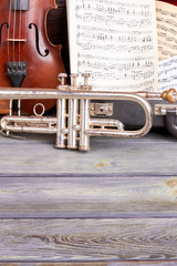 Musical background with classical instruments. Violin, trumpet, musical notes and copy space. Symphonic music objects.