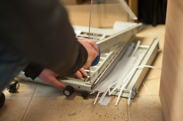 The worker cuts paper on a paper cutter