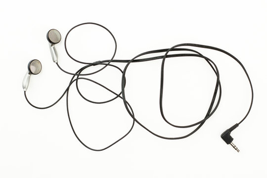 Grey earbuds over white background. Modern portable audio earphones isolated. Personal audio accessory.