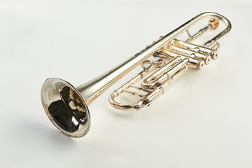 Old orchestra instrument on light background. Rusty trumpet instrument with clipping path.