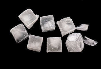 Cubes of Ice isolated on black Background,  pieces of crushed ice with Snow on Top