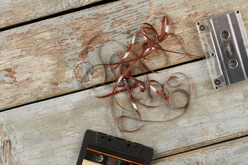 Audio cassettes on rustic wooden surface. Magnetic tape cassettes on old wooden floor....