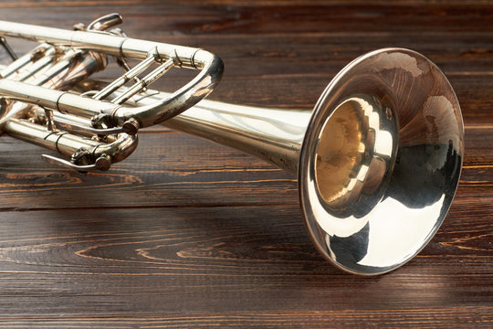 Close up trumpet on wooden background. Jazz music instrument. Instrument of classical music.