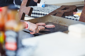 Preparing juicy burger cutlets on grill