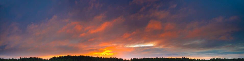 Panorama of the sky with beautiful colored whimsical clouds