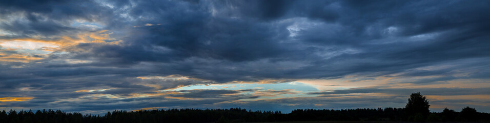Fototapeta premium Panorama of the sky with beautiful colored whimsical clouds