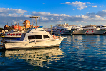 White yachts in the sea harbor of Hurghada, Egypt. Port with tourist boats on the Red Sea