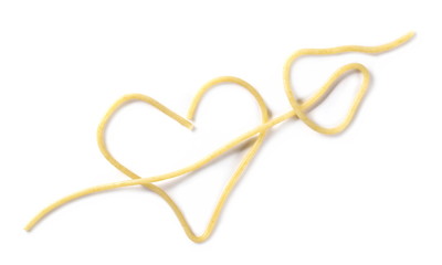 Fototapeta premium Spaghetti in shape heart and arrow, pasta isolated on white background, top vie