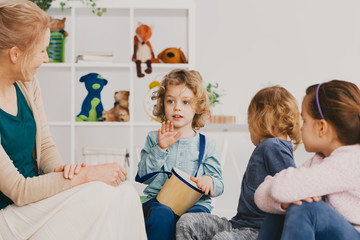 Kids during music lesson in kindergarten