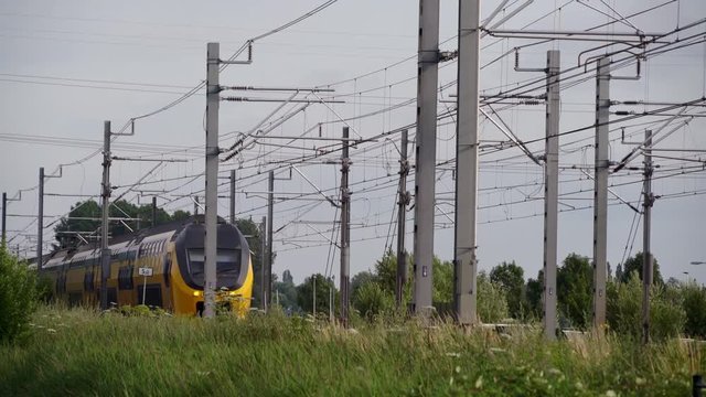 Dutch Double Decker train passes in high speed near Utrecht on a sunny day, Utrecht, The Netherlands, July 12th 2019