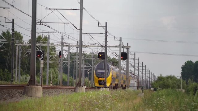 Dutch Double Decker train passes in high speed near Hilversum and Utrecht on a sunny day