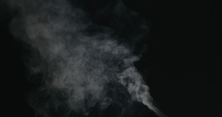 water vapor stream comes from below over black background with motion blur