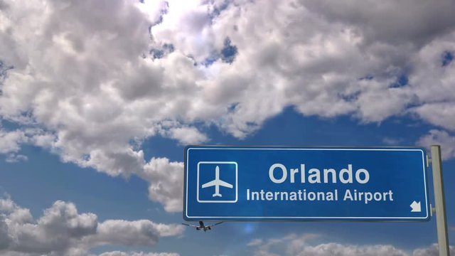 Jet airplane landing in Orlando, Florida, USA. City arrival with airport direction sign. Travel, business, tourism and transport concept.