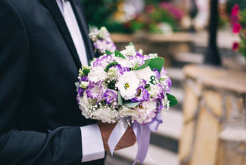 groom with a bouquet. wedding ceremony gathering bride and groom. two mr and mrs