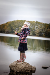 lovely girl standing by the pond
