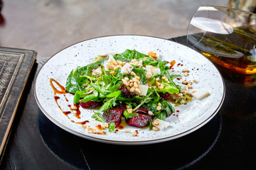 Close up view on fresh and healthy salad with lettuce, arugula, boiled beets and cheese. Vegan food. Helathy food concept. Healthy vegetarian dinner. Superfood, vegan, dieting food concept