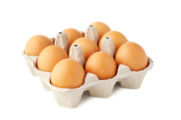 Nine brown fresh eggs in retail tray on white