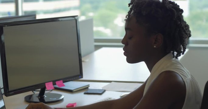 African American Woman in Office Typing on Computer