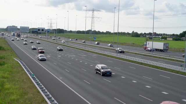 Commuters in cars driving on highway A1 from Amsterdam to the south seen from the front, Muiden, The Netherlands, July 9th 2019