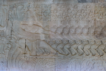 Famous bas reflief carved in the wall of Angkor Wat temple, world heritage and most visited tourist site, Cambodia. Details, close up of epic battles rock carving.