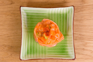 salmon sashimi with caviar and avocado served on a plate