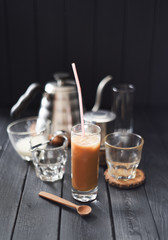 Iced coffee with coconut milk in tall glass Vietnamese style on black background