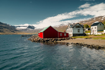 Old red classic Icelandic houses at the fish port of Eskifjordur. Easternfjords Iceland.