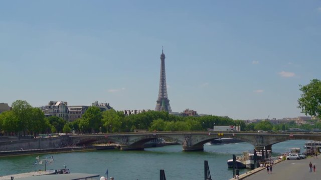 The Eiffel tower seen from the Pont (bridge) Alexandre III with in the foreground the river Seine in Paris, France, July 3th 2019