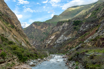 Fototapeta na wymiar Apurimac river : Green steep slopes of valley with water in the middle, the Choquequirao trek, Peru