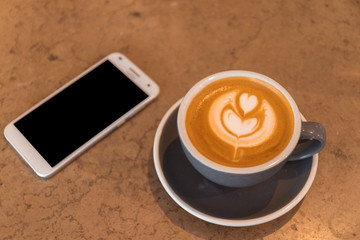 Cup of Latte coffee with smart phone