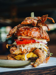 Giant burger with seafood crab shrimps cheese in cafe