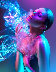 Zelfklevend Fotobehang Mannequin vrouw in kleurrijke felle neonlichten poseren in studio door transparante film. Portret van mooi sexy meisje in UV. Art design kleurrijke make-up © Subbotina Anna