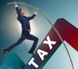 Businessman jumping over tax in tax evasion avoidance concept