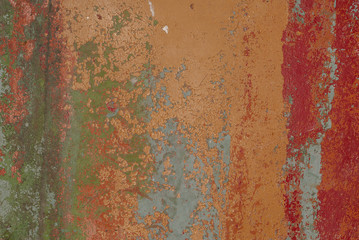 old wooden surface in a brown colour with pieces of peeling red paint, texture background