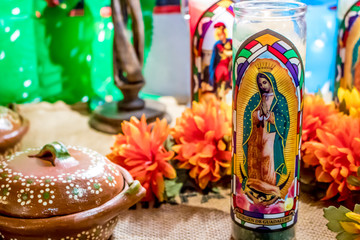 Closeup of an Altar with Saint Candles and Marigolds Displaying Traditional Mexican Pottery for the Day of the Dead Holiday in San Diego, California, USA