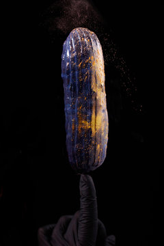 Beautiful bright eclair with blets on a dark background.