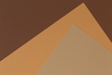 Color papers geometry composition banner background with beige, light brown and dark brown tones.