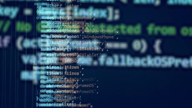 Working computer with a programming code on a screen.