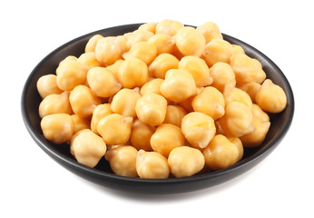 chickpeas in black bowl isolated on white background