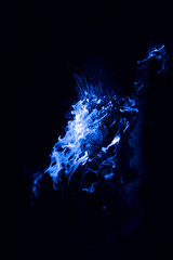 Blue flame. Burning of rice straw at night.