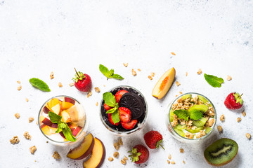 Fruit Dessert in glasses with yogurt and berries.