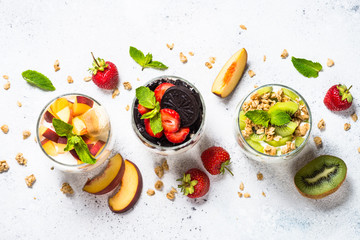 Fruit Dessert in glasses with yogurt and berries.