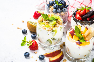 Fruit Dessert in glasses with yogurt and berries.