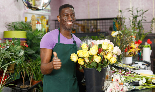 Successful florist giving thumbs up